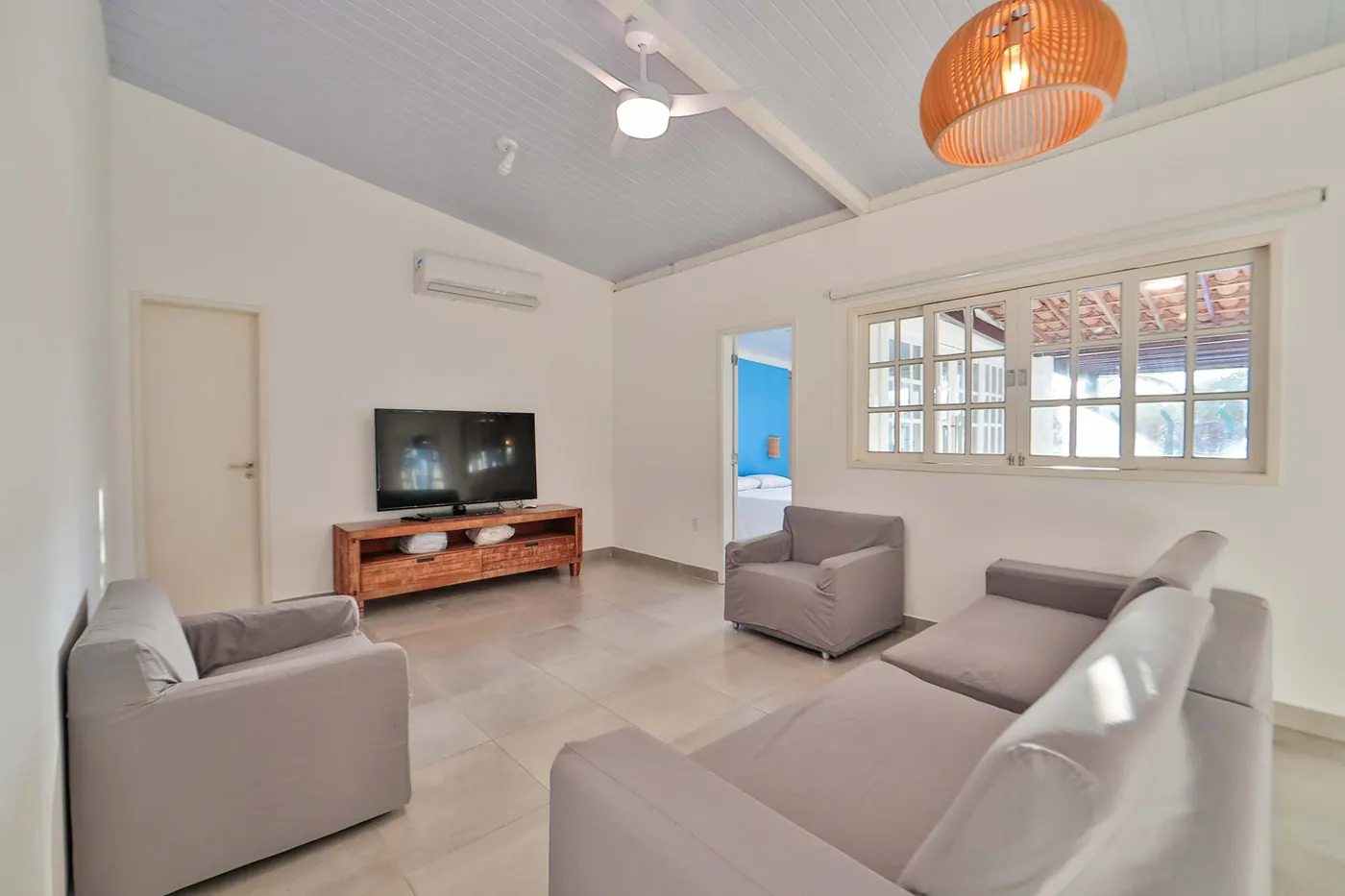 Villa com Piscina Privativa — sala de estar ampla com sofá e TV